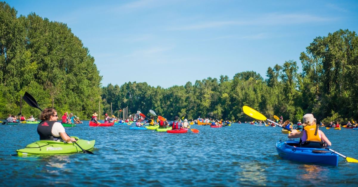 Lake River filled with dozens of kayakers and paddle boarders 