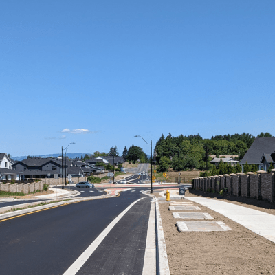 A street leading to the empty Wells Drive and Royle Road roundabout.
