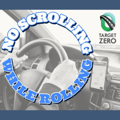 Hands on a car steering wheel with text 'No Scrolling While Rolling' and Target Zero logo.