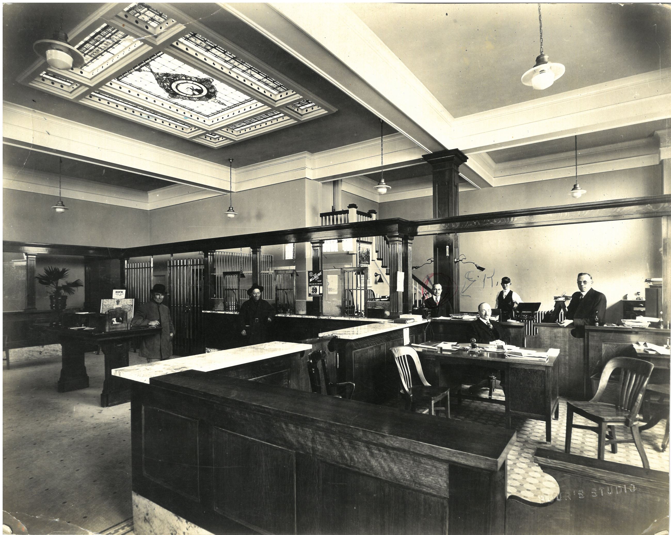 Interior of Ridgefield State Bank with 5 men positioned around the building.