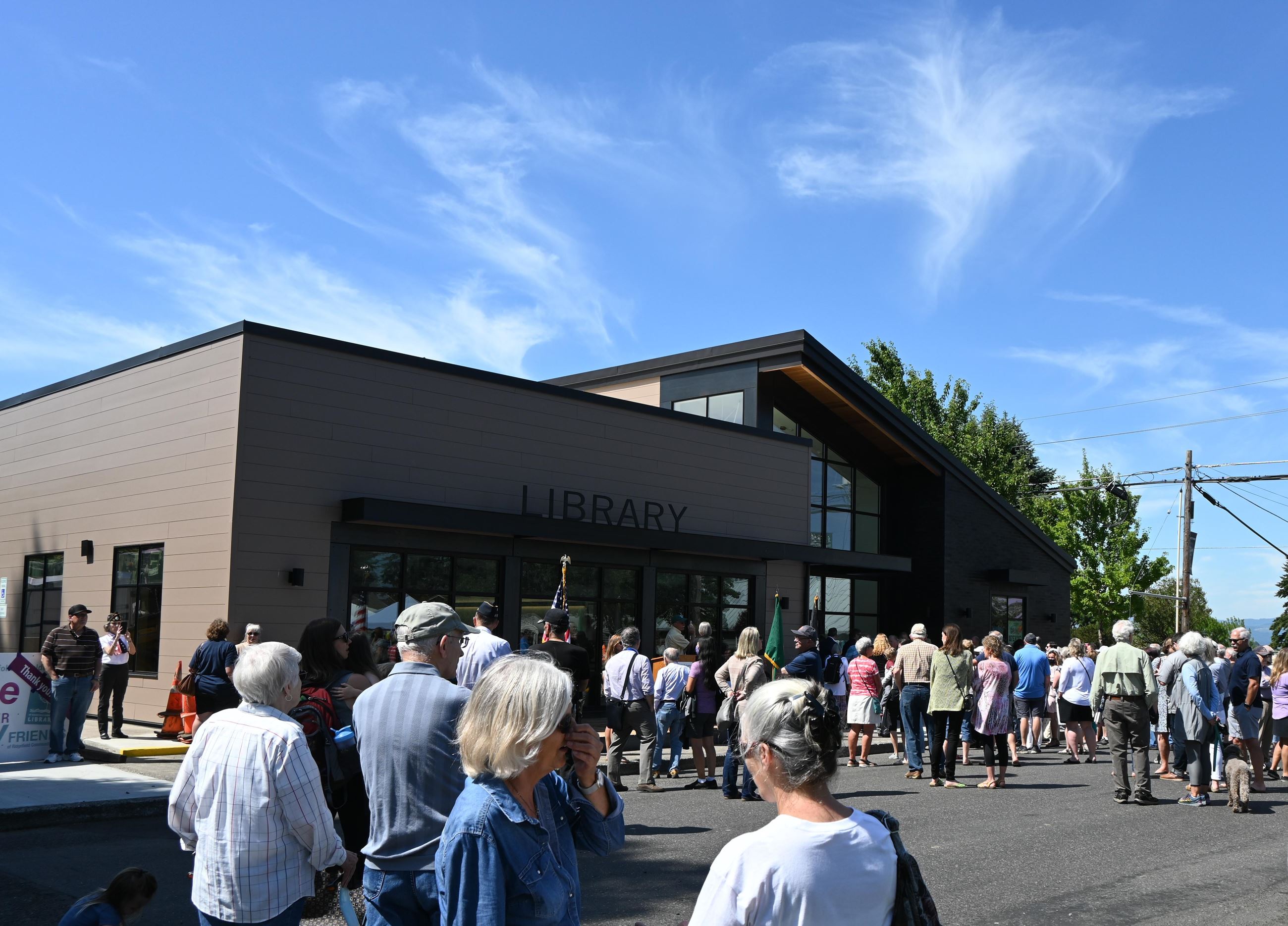 People grouped in front of the new Ridgefield Community Library.