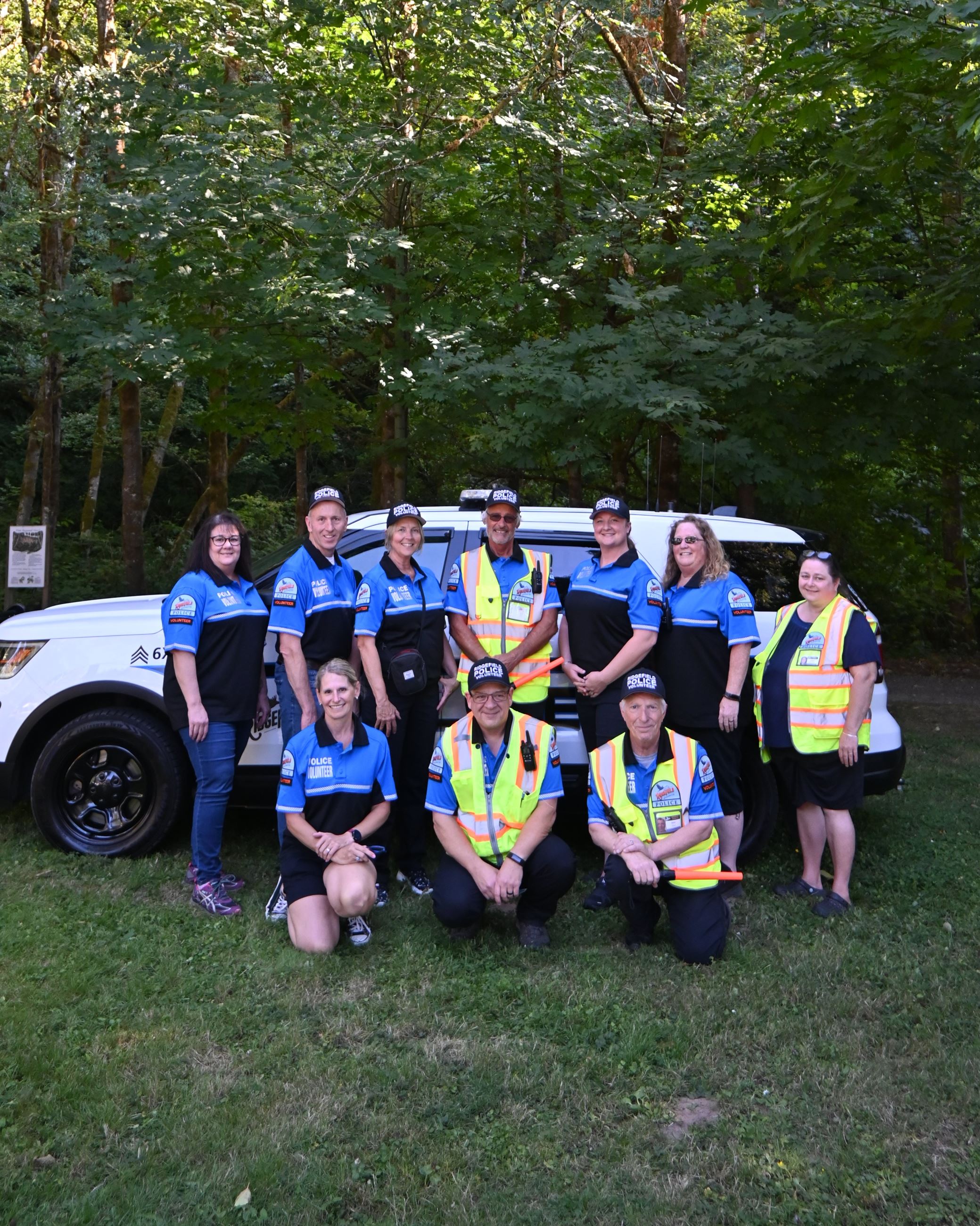 Members of NOW in volunteer uniform pose together.