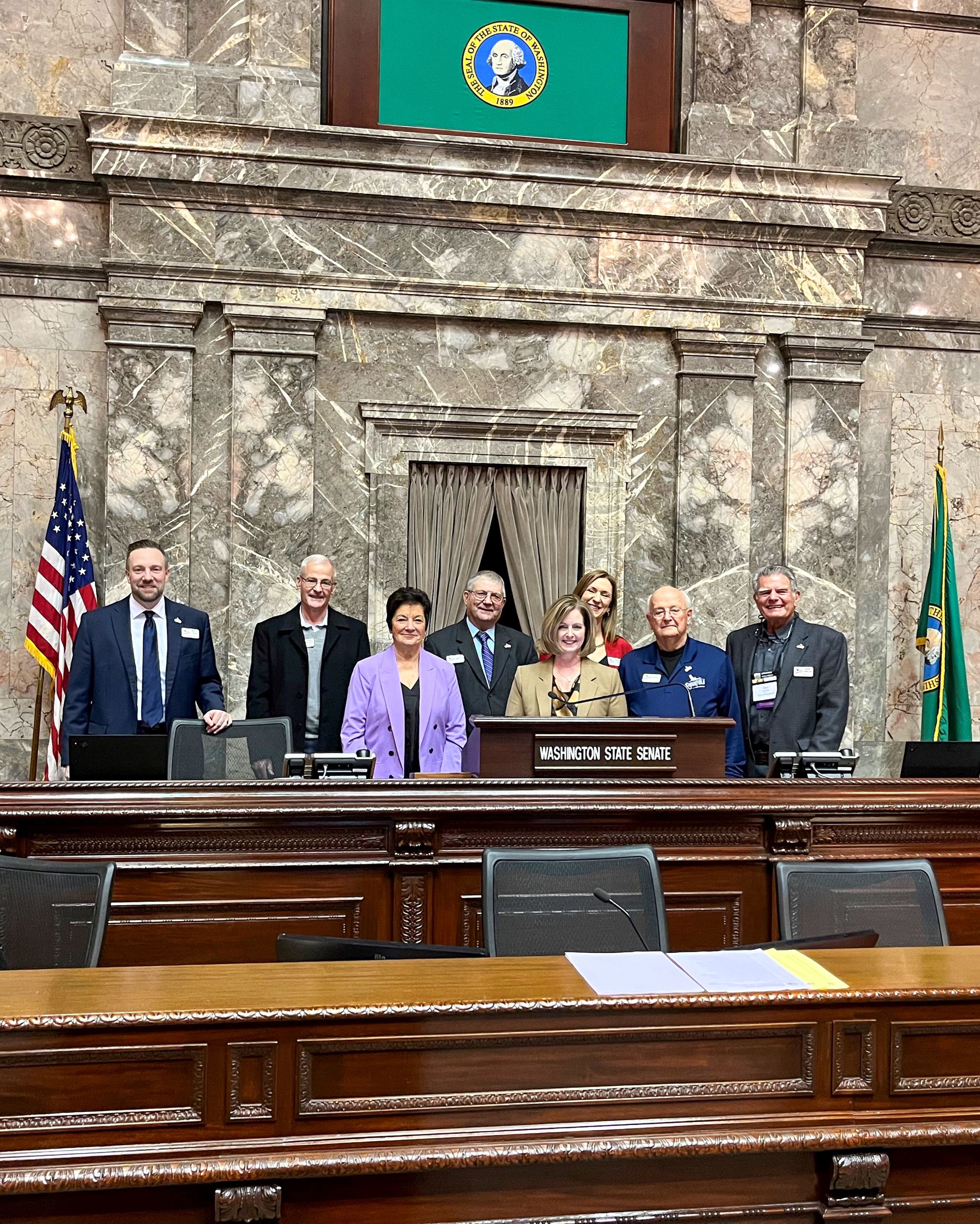 All seven City Councilmembers stand with Senator Annette Cleveland in the Washington State Senate Ch
