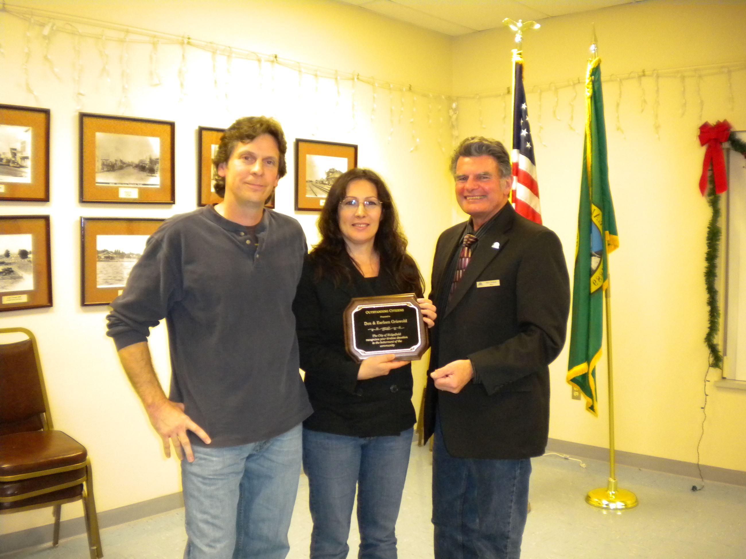 Don and Earleen Griswold stand with Ron Onslow holding Outstanding Citizen plaque.