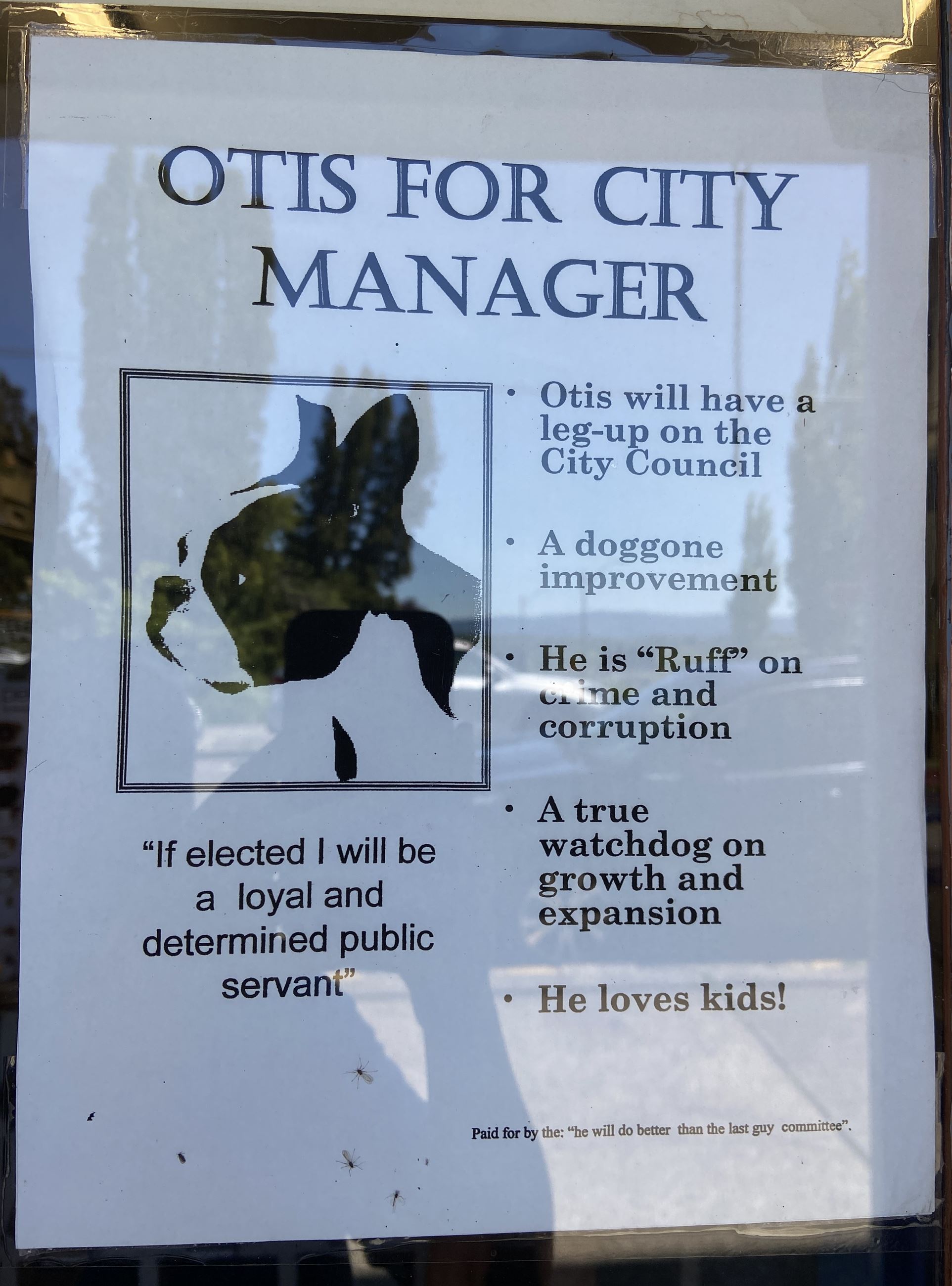 Black and white flyer posted on a door with title 'Otis for City Manager.'