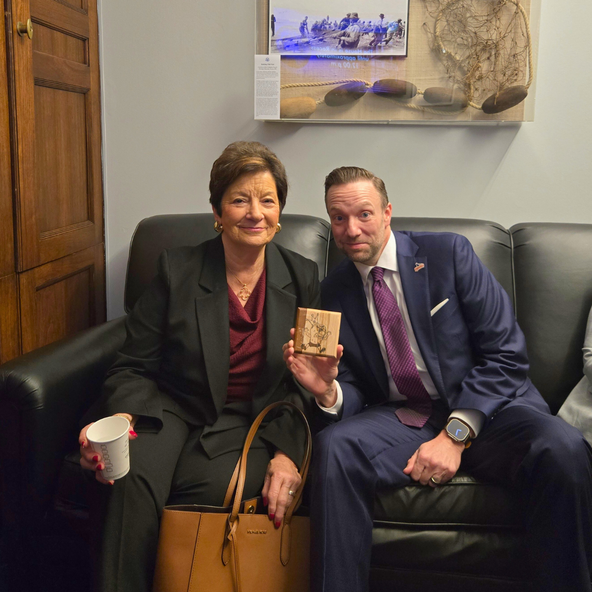 Mayor Cole holds up the Spudder coaster found in Rep. Gluesenkamp Perez' office.
