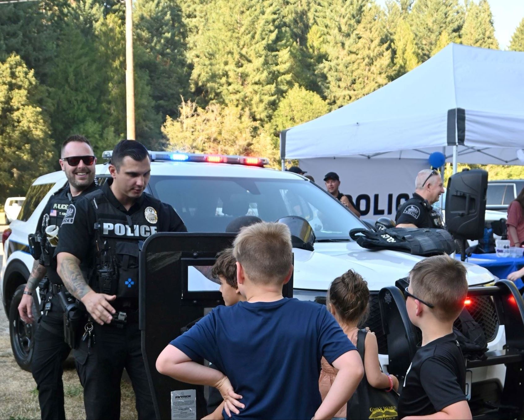Ridgefield Police Officers showing children their ballistic gear at National Night Out.